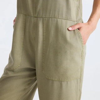 Roark Women's Costa Jumpsuit in Dusty Olive, relaxed fit lightweight woven jumpsuit in 60% organic cotton 40% Tencel with adjustable back straps, front and back patch pockets