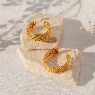 Polished gold hoop earrings with rounded classic silhouette.