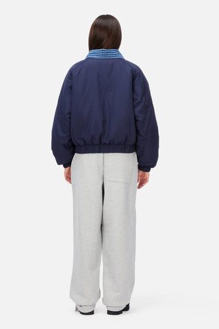 Front view of Dime Reversible Bomber Jacket in Navy with a blue plaid collar, full-length zipper, raglan sleeves, and gathered cuffs and hem