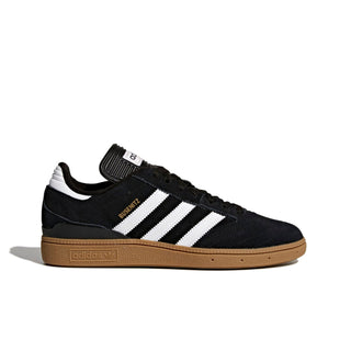 Black Adidas sneaker with white stripes on a light gray background