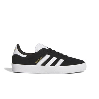 Adidas Gazelle ADV skate shoe in Core Black, Cloud White, and Gold Metallic — low-profile suede upper with cupsole construction and reinforced ollie zone.