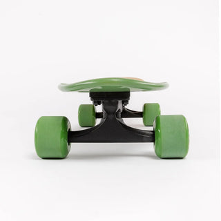 “Sector 9 Bambino Bivy complete skateboard with natural bamboo finish, green nose and wheels, black trucks, and beach camping badge artwork.”