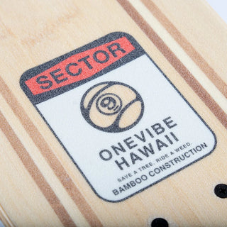 “Sector 9 Bambino Shorebreak complete skateboard with turquoise wave and lifeguard tower artwork, red wheels, black trucks, and a natural bamboo top.”