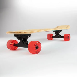 “Sector 9 Bambino Shorebreak complete skateboard with turquoise wave and lifeguard tower artwork, red wheels, black trucks, and a natural bamboo top.”