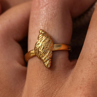 Gold conch shell-inspired ring with sculpted polished finish.