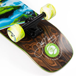 “Sector 9 Cascade Ninety Five complete skateboard showing mossy forest stream photography, woodgrain detailing, green-and-white wheels, and black grip tape.”