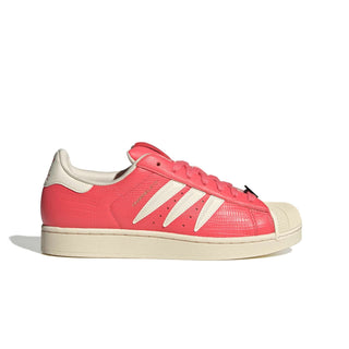 adidas Originals Pokémon Superstar II "Charmeleon" in Preloved Scarlet/Preloved Scarlet/Cream White — full leather upper with Charmeleon scale-like skin texture, 3-Stripes shaped into claws, Charmeleon character on tongue label, sockliner, and lace jewel
