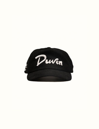 Black corduroy unstructured hat with shark bite embroidery and Duvin branding.