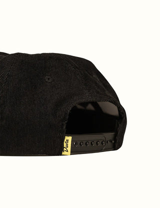 Black corduroy unstructured hat with shark bite embroidery and Duvin branding.
