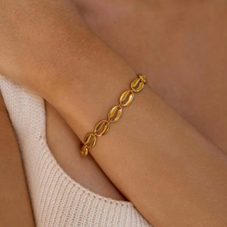 ALCO Puka Shell bracelet in 18K gold-plated stainless steel with lobster clasp, 6 inch length, and extender.