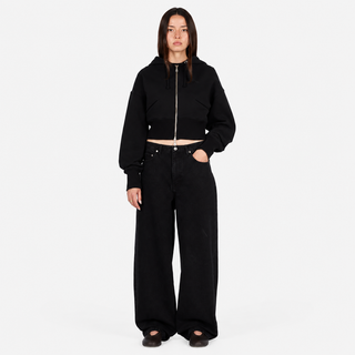 Front view of Dime Women’s Baggy Denim Pants in Black with wide legs, curved front pockets, a coin pocket, and belt loops