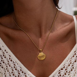 Gold necklace with minimalist design and polished finish, styled with a delicate chain and lobster clasp.