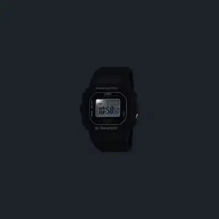 Black G-SHOCK DWN5600-1 ring watch with digital display on finger.