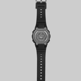 Black G-SHOCK DWN5600-1 ring watch with digital display on finger.