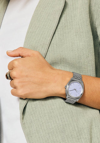 Nixon Time Teller Silver/Lavender analog watch with stainless steel bracelet and soft lavender dial.