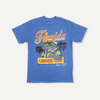 Duvin x Florida Gators Leisure Club Tee with orange Florida lettering and Albert wearing sunglasses and a Hawaiian shirt behind a Leisure Club sign.