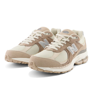 New Balance 2002R Sneakers in Driftwood with Sandstone and Moonbeam. These sneakers feature a retro-inspired design with a premium suede and mesh upper and a cushioned midsole for comfort.
