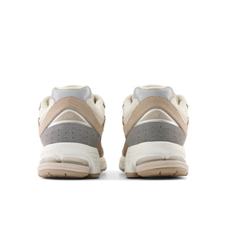 New Balance 2002R Sneakers in Driftwood with Sandstone and Moonbeam. These sneakers feature a retro-inspired design with a premium suede and mesh upper and a cushioned midsole for comfort.