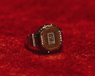 Digital watch on a red textured surface