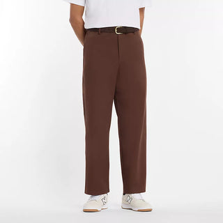 New Balance Numeric Standard Pant in Pumpernickel with lightweight cotton twill stretch fabric, straight leg, single pleat, 3-pocket design, zippered stash pocket, and elastic waistband