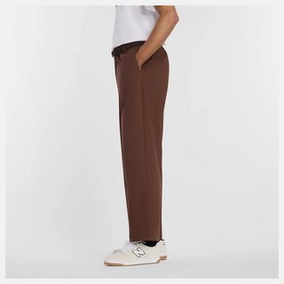 New Balance Numeric Standard Pant in Pumpernickel with lightweight cotton twill stretch fabric, straight leg, single pleat, 3-pocket design, zippered stash pocket, and elastic waistband