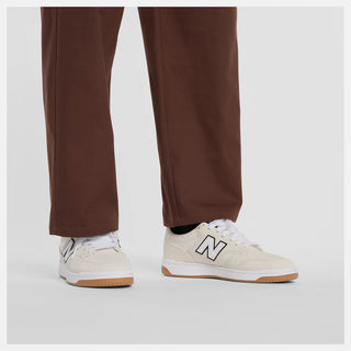 New Balance Numeric Standard Pant in Pumpernickel with lightweight cotton twill stretch fabric, straight leg, single pleat, 3-pocket design, zippered stash pocket, and elastic waistband