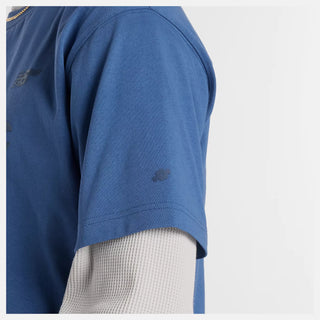 New Balance Numeric Cotton Tee in Magic Blue with 100% cotton jersey fabric, relaxed loose fit, ribbed collar, and rubberized high density branding