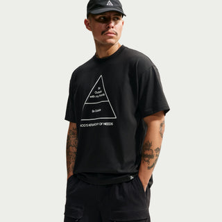 Front view of the black Nike ACG Hierchy Dri-FIT Tee with a white Hierarchy of Needs triangle graphic, worn by a model.