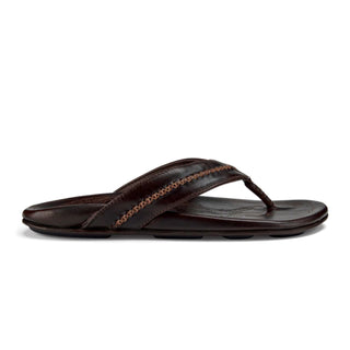 OluKai Mea Ola Leather Sandals in Dark Java/Dark Java — premium full-grain leather with canoe lash whipstitching, octopus laser-etched footbed, microfiber lining, and handsewn leather toe post