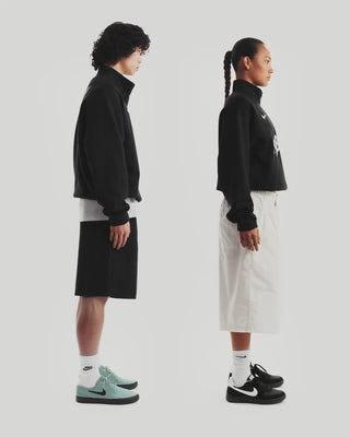 Nike SB Club 58 black half-zip fleece sweatshirt with adjustable hem and relaxed fit.