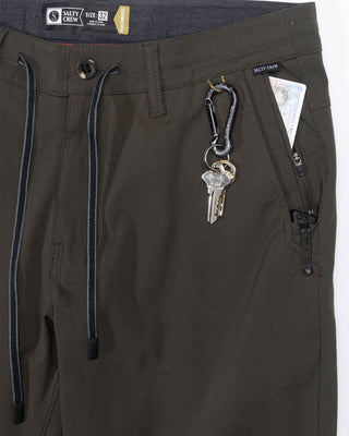 Salty Crew Transom Tech Pants Deep Forest with recycled stretch fabric, quick-dry performance, utility pockets, and adjustable drawcord waist.