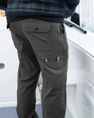 Salty Crew Transom Tech Pants Deep Forest with recycled stretch fabric, quick-dry performance, utility pockets, and adjustable drawcord waist.