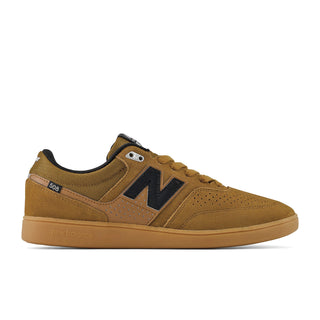 A New Balance 508 sneaker in a brown and tan colorway, featuring a suede and mesh upper, a black 'N' logo, and a gum rubber sole, shown from a side profile on a white background.