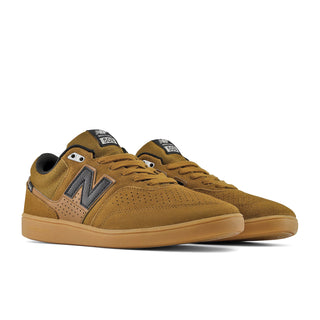 A pair of New Balance 530 skate shoes in a warm brown suede and leather combination, featuring a dark brown 'N' logo and a gum rubber sole, set against a plain white background.