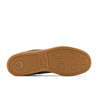 The outsole of a New Balance shoe in a warm brown gum rubber, showing the tread pattern and embossed 'NB' logo, on a white background.