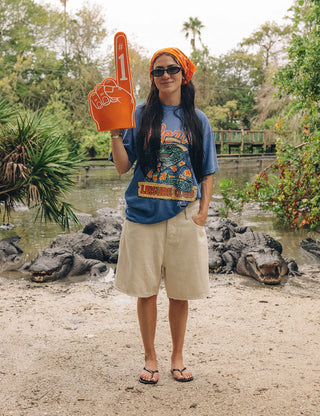 Duvin x Florida Gators Leisure Club Tee with orange Florida lettering and Albert wearing sunglasses and a Hawaiian shirt behind a Leisure Club sign.