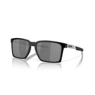 Oakley Exchange Sun Sunglasses in Satin Black with Prizm Black lenses, mixed material O Matter front with stainless steel temples and B1B grip textured Unobtainium earsocks, 11% light transmission grey base lens optimized for bright light, heritage-inspired design