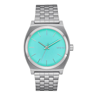 An image of the Nixon Time Teller Silver/Turquoise watch, showcasing its sleek silver design and stainless steel bracelet.