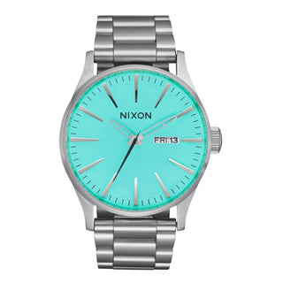Nixon Sentry Stainless Steel Watch, Silver case, Turquoise dial, 3-link bracelet, day and date display.