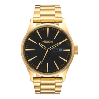 Nixon Sentry Stainless Steel Watch in Yellow Gold with Black dial, day/date display, and stainless steel bracelet.