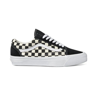 Black and white Vans Old Skool shoes with checkerboard canvas, suede overlays, white Sidestripe, and white rubber outsole.