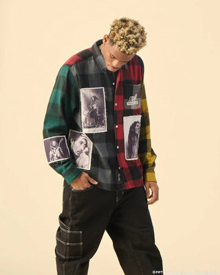 Man wearing the Primitive Marley Patchwork Flannel, a heavy-weight, multi-colored panel cotton shirt with CF engraved buttons, a screen-printed artwork on the left chest pocket flap, and custom Bob Marley sublimated patches