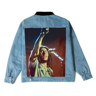 Individual wearing the Primitive Skate Stand Up Jacket, a 100% cotton denim piece with a light-weight cotton flannel liner, a corduroy collar, and custom sublimated back patch panel. Also features a front vislon, a slanted left chest zipper pocket with Bob Marley label, lower slanted welt pockets, adjustable sleeve cuffs, and lower back tabs.