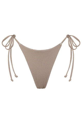 Frankies Bikinis Skimpy Venice bottom with string side ties and a romantic textured gingham jacquard fabric. This wanderlust-inspired bikini bottom is perfect for lounging by the pool or soaking up the sun on the beach. The adjustable side ties allow you to customize the fit to your liking. Crafted from a premium blend of 46% nylon, 46% polyester, and 8% spandex gingham, this bikini bottom feels soft and comfortable against your skin.